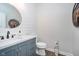 Powder room with shiplap walls, decorative mirror, vanity with stone countertop, and neutral decor at 6459 Canak Dr, Avon, IN 46123