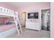 A childs pink bedroom features a bunk bed, dresser, and TV at 6459 Canak Dr, Avon, IN 46123