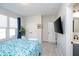 Bright bedroom featuring a blue floral comforter, white trim, and a large window with natural light at 6459 Canak Dr, Avon, IN 46123
