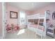 A childs pink bedroom features a bunk bed, and a window providing plenty of natural light at 6459 Canak Dr, Avon, IN 46123