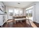Sunlit dining area with a wooden table, bench seating, and sliding glass doors to the outdoor deck at 6459 Canak Dr, Avon, IN 46123