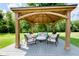 Backyard gazebo featuring cushioned seating and a round coffee table at 6459 Canak Dr, Avon, IN 46123