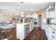 Open concept kitchen with island seating, granite countertops, stainless appliances, and view of the living room at 6459 Canak Dr, Avon, IN 46123