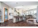 Bright kitchen features a large island with seating, pantry, stainless steel appliances, and adjacent dining area at 6459 Canak Dr, Avon, IN 46123