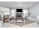 Cozy living room with hardwood floors, a stone fireplace, and modern decor at 6459 Canak Dr, Avon, IN 46123