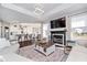 Open-concept living room with a fireplace, hardwood floors, and views of the kitchen and dining area at 6459 Canak Dr, Avon, IN 46123