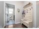 Mudroom with built-in bench, hooks for storage, patterned flooring, and laundry room access at 6459 Canak Dr, Avon, IN 46123