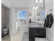 Bright bathroom featuring double sinks, granite counters, a large mirror, and plenty of natural light at 6922 Kara Ln, Brownsburg, IN 46112
