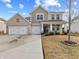 Charming two-story brick and shake home with a three-car garage and a well-manicured front lawn at 6922 Kara Ln, Brownsburg, IN 46112