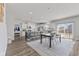 Open-concept kitchen with a central island, modern appliances, and dining area with natural light at 6922 Kara Ln, Brownsburg, IN 46112