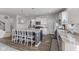 Well-lit kitchen with an island featuring bar seating, granite countertops, and stainless steel appliances at 6922 Kara Ln, Brownsburg, IN 46112