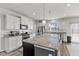 Bright and functional kitchen with an island, granite counters, and stainless steel appliances at 6922 Kara Ln, Brownsburg, IN 46112