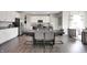 Open concept dining area with hardwood floors and decorative lighting near the kitchen at 7397 Standish Ln, Avon, IN 46123