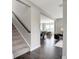 Hallway with staircase leading to an open living area with hardwood floors at 7397 Standish Ln, Avon, IN 46123