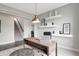 Bright study featuring a desk, chair, ottoman, shelving, and a view of the staircase at 7397 Standish Ln, Avon, IN 46123