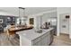Bright kitchen with stainless steel appliances, island with sink, and a seamless flow into the dining and living areas at 7516 Fallsworth Dr, Avon, IN 46123