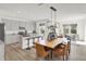Open-concept kitchen and dining area with a large island, modern appliances, and stylish decor at 7516 Fallsworth Dr, Avon, IN 46123