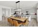 Spacious dining area and kitchen with an oversized island, stainless appliances and wood floors at 7516 Fallsworth Dr, Avon, IN 46123