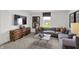 Cozy living room with a decorative wood cabinet and a comfortable gray sectional sofa at 7516 Fallsworth Dr, Avon, IN 46123