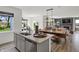 Open-concept view of a living room that flows to the kitchen with stainless steel appliances and a large dining table at 7516 Fallsworth Dr, Avon, IN 46123