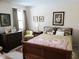 Cozy bedroom featuring wood furniture, a decorative quilt, and bright natural light from the window at 7682 Micawber Ct, Indianapolis, IN 46256