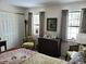 Bright bedroom with natural light, featuring vintage dresser and hardwood floors at 7682 Micawber Ct, Indianapolis, IN 46256