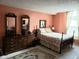 Cozy bedroom features warm-toned walls, a comfortable bed, and traditional wooden furnishings at 7682 Micawber Ct, Indianapolis, IN 46256