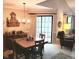 Well-lit dining area featuring a wooden table, sliding glass doors, and decor at 7682 Micawber Ct, Indianapolis, IN 46256