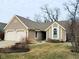 Charming single Gathering home featuring a two-car garage and manicured front lawn at 7682 Micawber Ct, Indianapolis, IN 46256