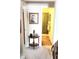 Hallway features a console table and artwork, view into the bath at 7682 Micawber Ct, Indianapolis, IN 46256