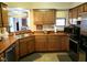 Traditional kitchen features wood cabinetry, stainless steel appliances, and tiled floors at 7682 Micawber Ct, Indianapolis, IN 46256