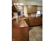 Functional kitchen featuring wooden cabinets, modern countertops, and tiled flooring at 7682 Micawber Ct, Indianapolis, IN 46256