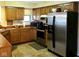 Well-equipped kitchen with stainless steel appliances, wooden cabinets, and modern lighting at 7682 Micawber Ct, Indianapolis, IN 46256