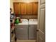 The laundry room features a washer and dryer, with storage above, providing convenience and functionality at 7682 Micawber Ct, Indianapolis, IN 46256