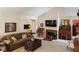 Bright living room boasts neutral walls, comfortable seating, and a classic fireplace at 7682 Micawber Ct, Indianapolis, IN 46256