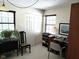 Bright office space featuring two windows, a closet, and a desk with rolling chair at 7682 Micawber Ct, Indianapolis, IN 46256