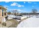 Spacious backyard with outdoor seating, barbecue grill, and partial lake view under a blue sky at 8329 Hill Gail Dr, Indianapolis, IN 46217