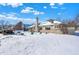 Home exterior with large backyard featuring manicured lawn and mature trees under a bright blue sky at 8329 Hill Gail Dr, Indianapolis, IN 46217