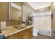 Well-lit bathroom featuring a glass vessel sink and shower at 8329 Hill Gail Dr, Indianapolis, IN 46217