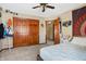 Bedroom featuring a ceiling fan, double closets, and an ensuite bathroom at 8329 Hill Gail Dr, Indianapolis, IN 46217