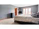 Bedroom with gray walls, a bed, a chest of drawers, and a window offering natural light at 8329 Hill Gail Dr, Indianapolis, IN 46217