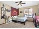 Cozy bedroom featuring a ceiling fan, and large windows with pink curtains at 8329 Hill Gail Dr, Indianapolis, IN 46217