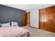 Cozy bedroom featuring neutral carpet, closet, and a contrasting accent wall at 8329 Hill Gail Dr, Indianapolis, IN 46217
