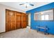 Bedroom featuring bright blue accent wall, carpet, and a closet at 8329 Hill Gail Dr, Indianapolis, IN 46217