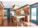 Well-lit kitchen features wood cabinets, granite countertops, island with seating, and stainless steel appliances at 8329 Hill Gail Dr, Indianapolis, IN 46217