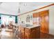 Kitchen features wood cabinets, granite countertops, island with seating, and breakfast area at 8329 Hill Gail Dr, Indianapolis, IN 46217