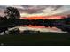 Picturesque lake view at sunset, featuring vibrant reflections of the colorful sky in the water at 8329 Hill Gail Dr, Indianapolis, IN 46217