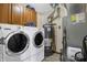 Laundry room with washer, dryer, water heater, and storage cabinets at 8329 Hill Gail Dr, Indianapolis, IN 46217