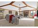 Inviting living room boasts beamed ceilings, a brick fireplace, plush seating, and bright natural light at 8329 Hill Gail Dr, Indianapolis, IN 46217