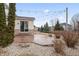 Well maintained backyard featuring large patio, gravel accents, bushes and mature trees at 10264 Normandy Way, Fishers, IN 46040